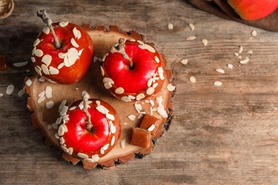 Delicious caramel apples on wooden serving board