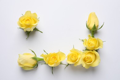 Beautiful yellow roses on white background, flat lay