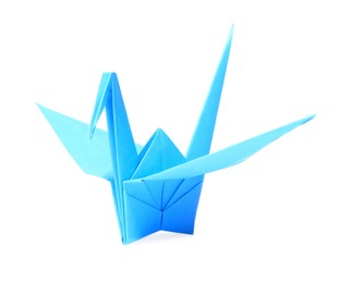 Photo of Origami art. Blue handmade paper crane isolated on white
