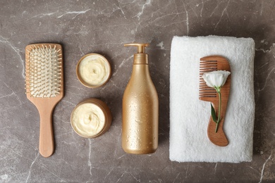 Photo of Flat lay composition with hair products and accessories on grey table