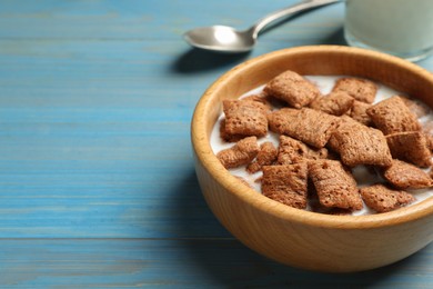 Tasty corn pads with milk served on turquoise wooden table, closeup. Space for text