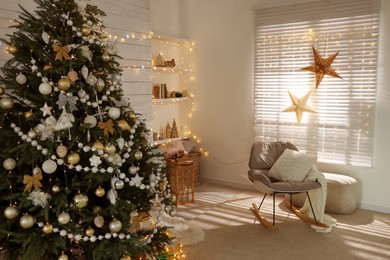 Photo of Decorated Christmas tree in stylish living room interior