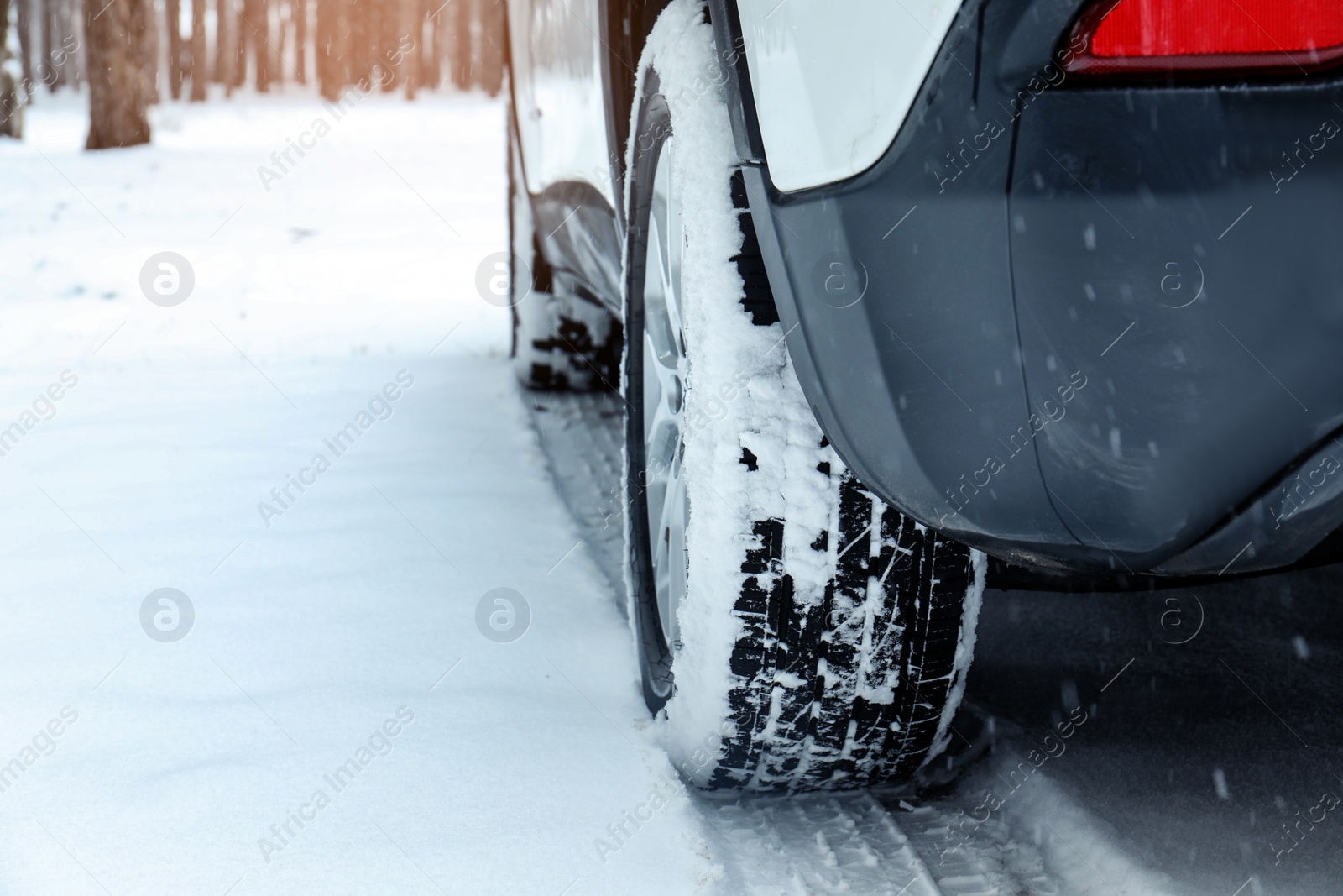 Photo of Modern car on snowy road, closeup view. Winter season