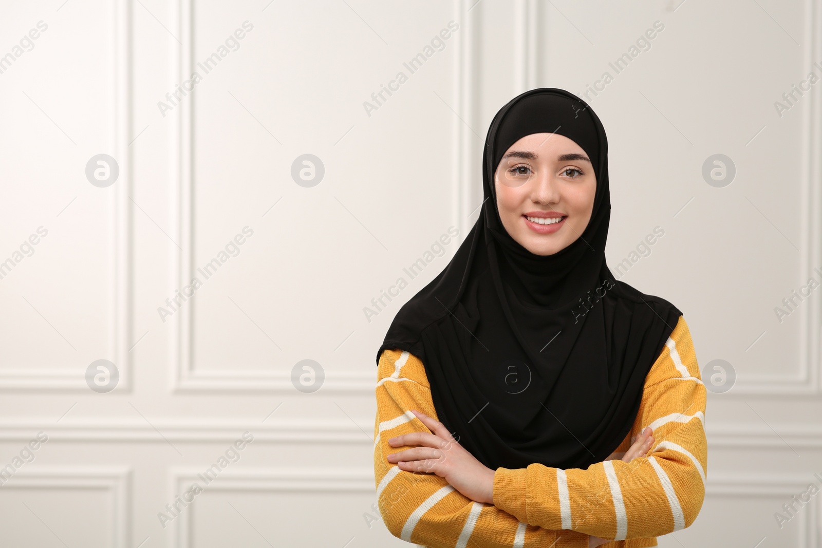 Photo of Portrait of Muslim woman in hijab indoors, space for text