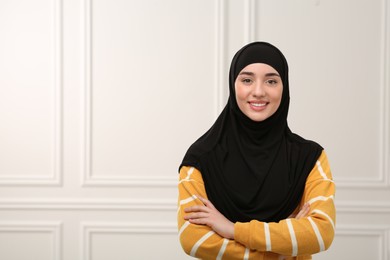 Portrait of Muslim woman in hijab indoors, space for text