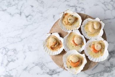 Fried scallops in shells on white marble table, top view. Space for text