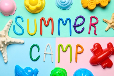 Flat lay composition with text SUMMER CAMP made of modelling clay on color background