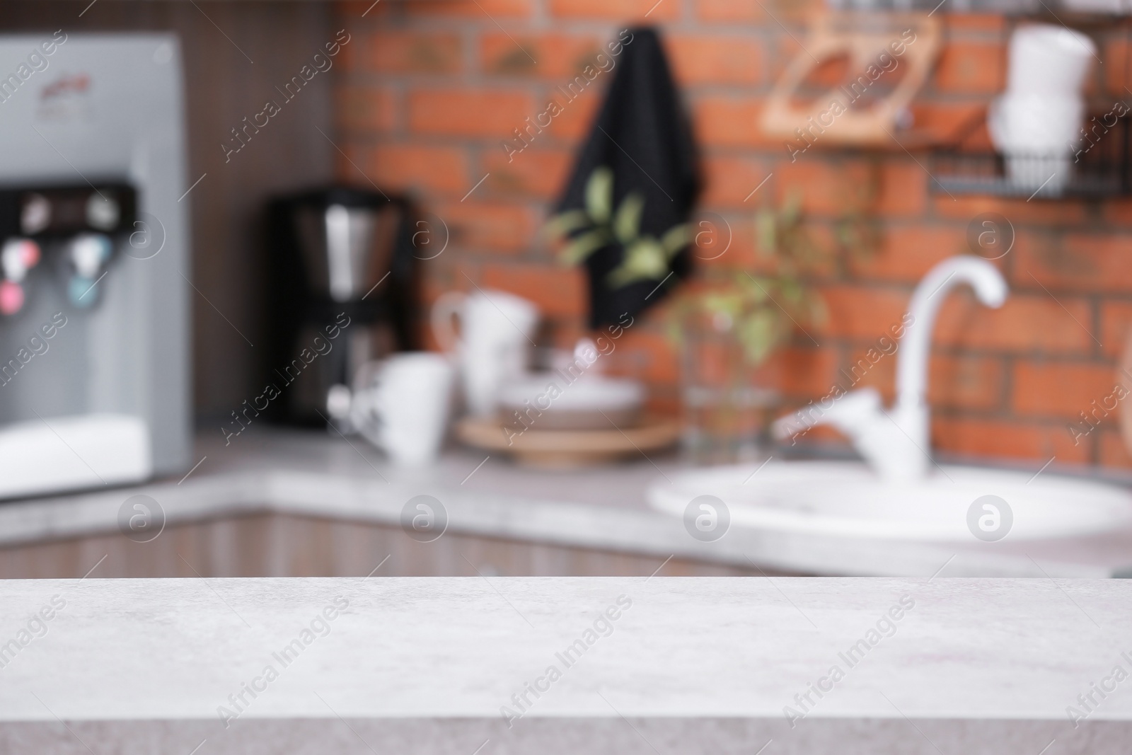 Photo of Countertop and blurred view of kitchen interior. Idea for home design