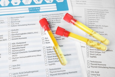 Photo of Test tubes with urine samples for analysis on laboratory test form