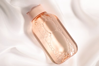 Photo of Bottle of micellar water on white fabric