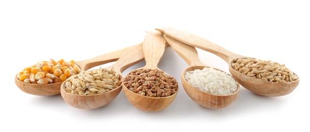 Spoons with different types of grains and cereals on white background