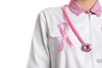 Doctor with pink ribbon and stethoscope on white background, closeup. Breast cancer awareness