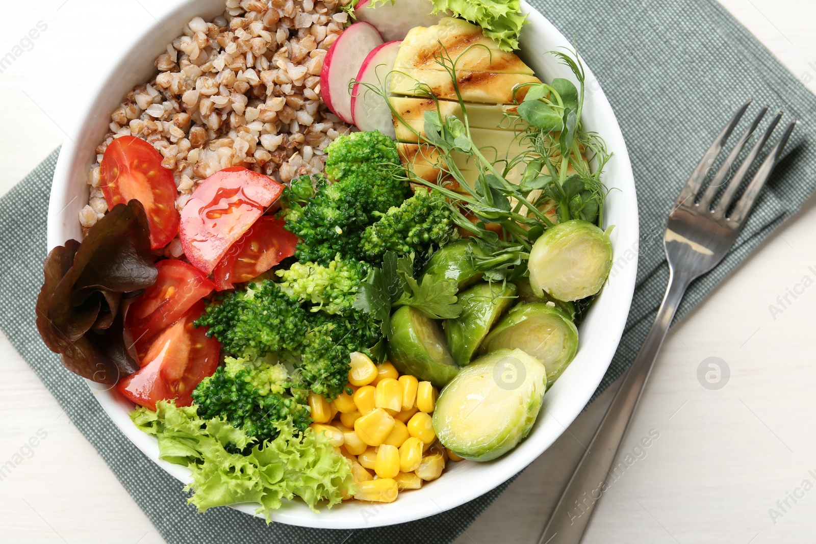 Photo of Healthy meal. Tasty products in bowl on white table, top view