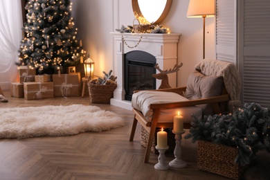 Beautiful room interior with armchair, Christmas tree and fireplace