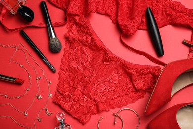 Photo of Flat lay composition with sexy lingerie on red background