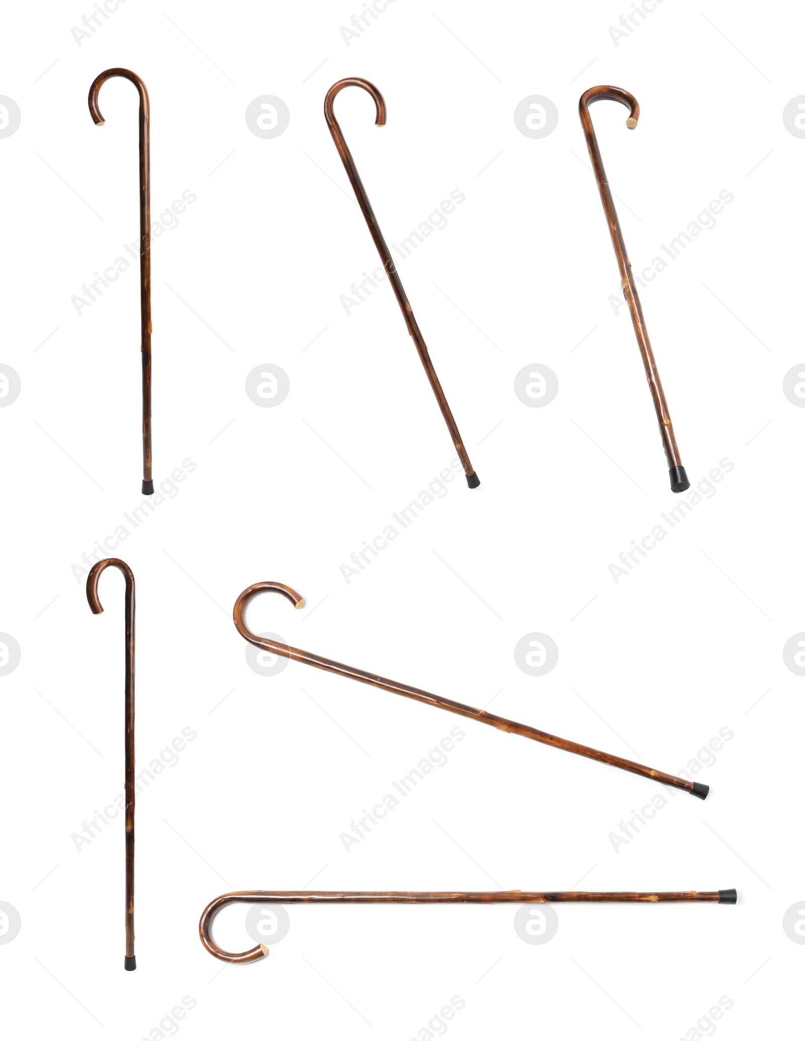 Image of Set with elegant wooden walking canes on white background