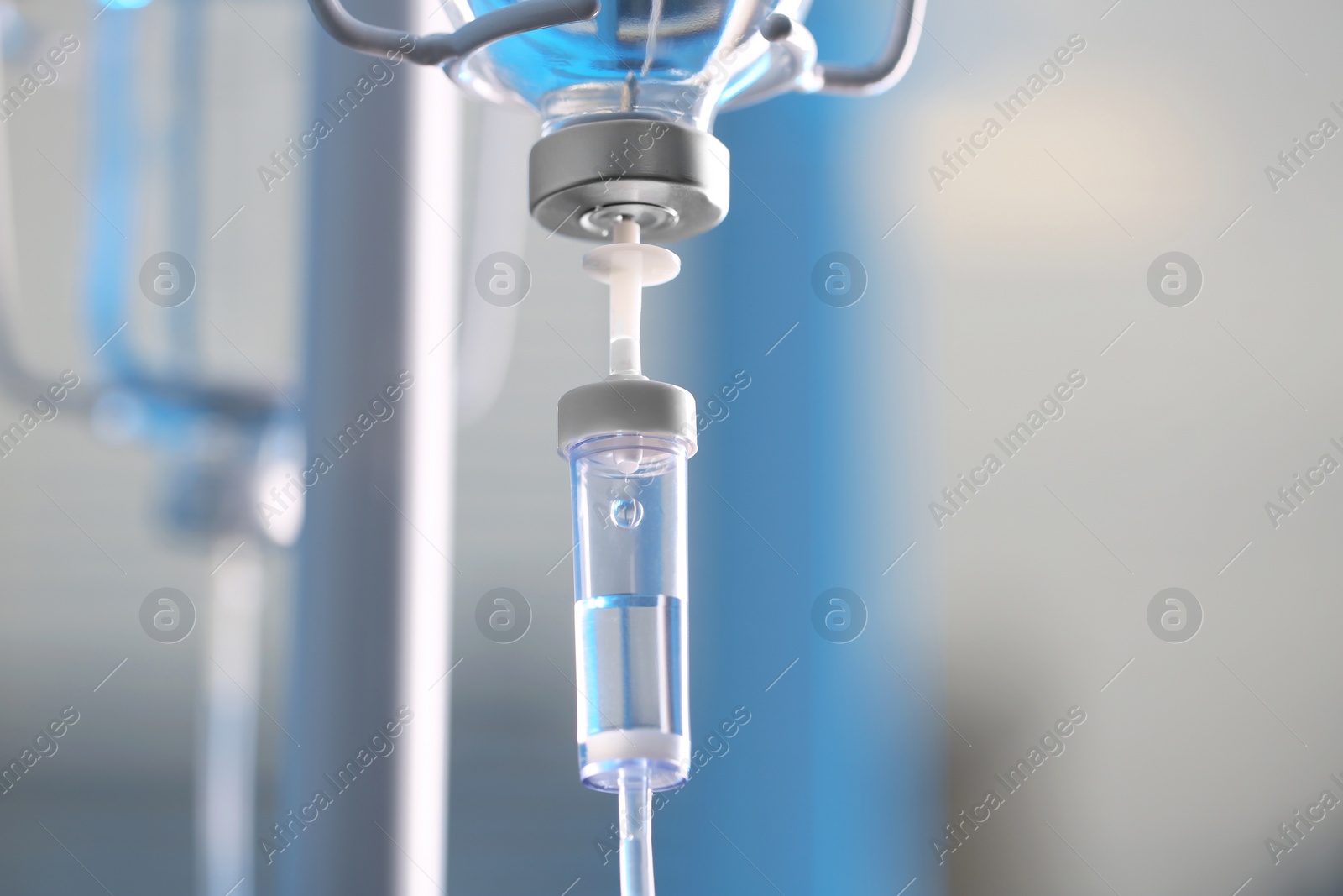 Photo of IV drip chamber against blurred light background