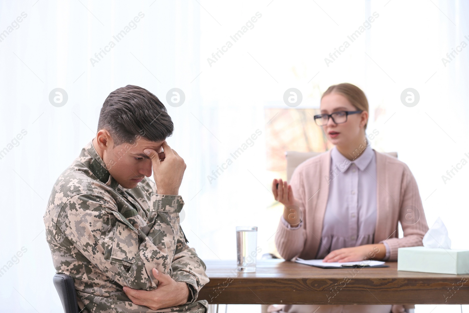 Photo of Psychotherapist working with military officer in office