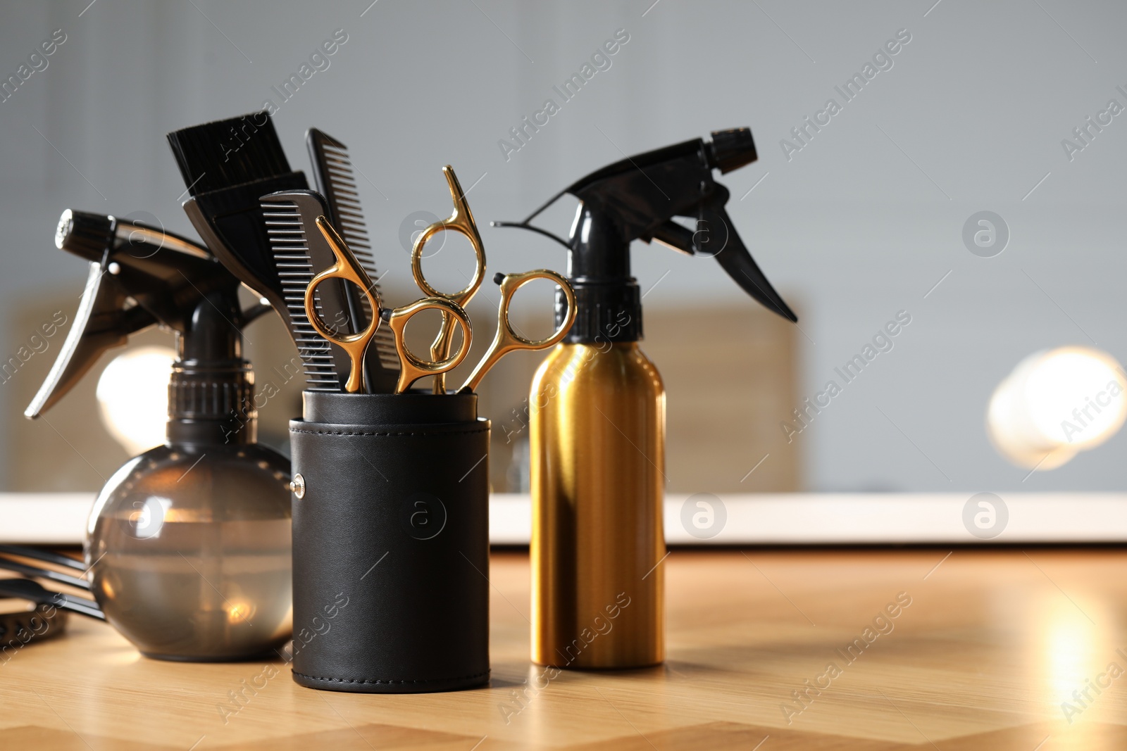 Photo of Set of hairdresser tools on table in salon, space for text