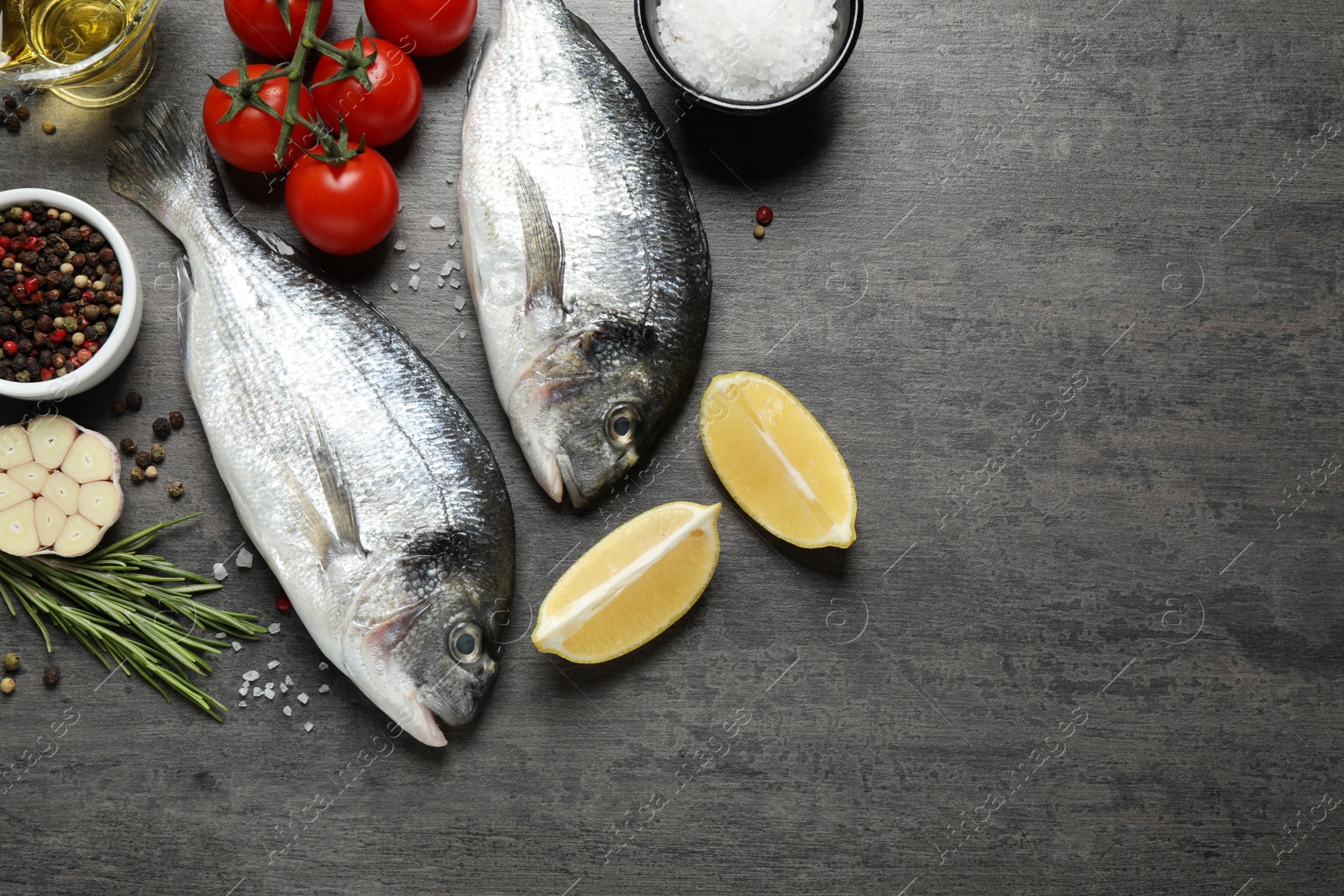 Photo of Flat lay composition with raw dorada fish on grey table