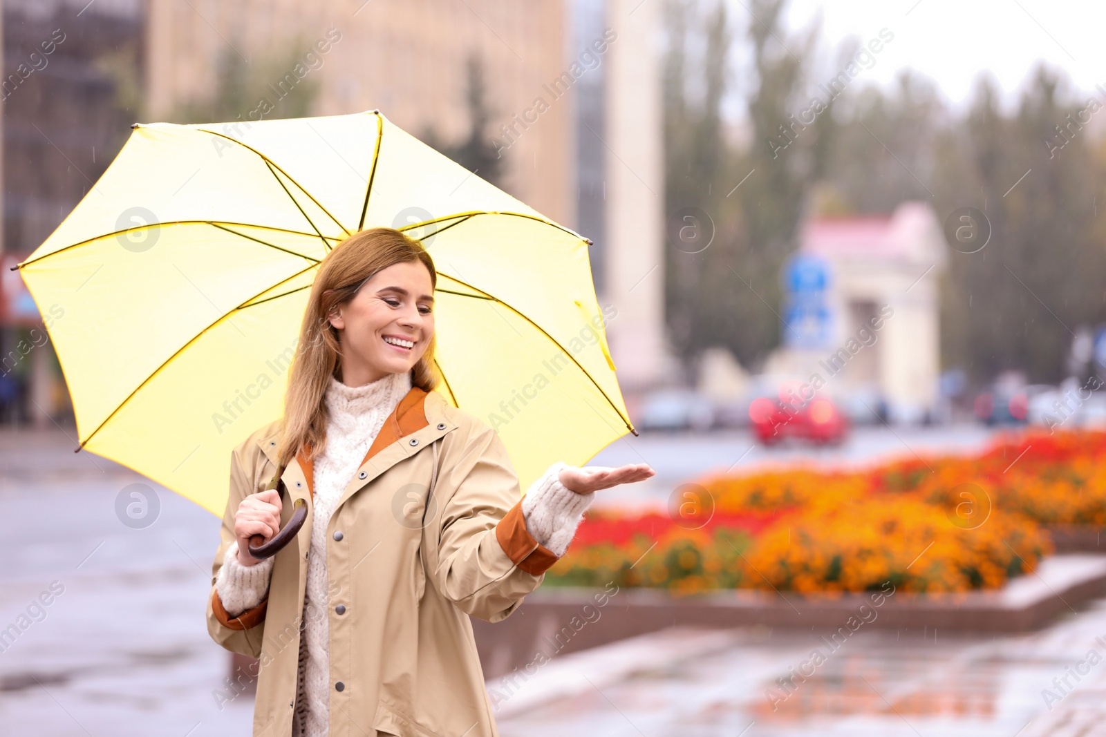 Photo of Woman with umbrella in city on autumn rainy day