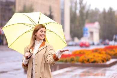 Photo of Woman with umbrella in city on autumn rainy day