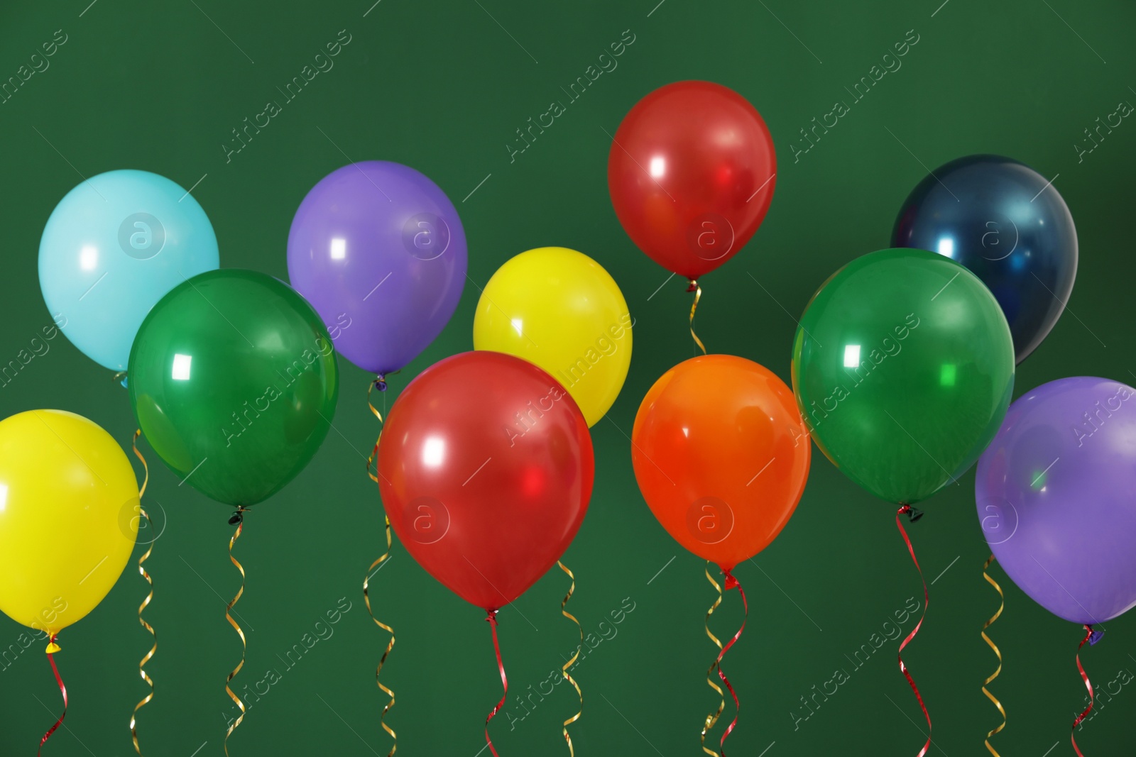 Photo of Bright balloons on color background. Celebration time