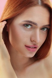 Photo of Portrait of beautiful young woman on pink background, closeup