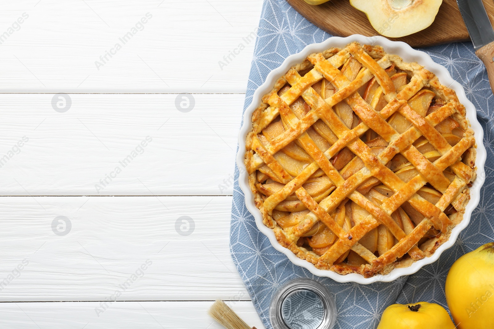Photo of Tasty homemade quince pie on white wooden table, flat lay. Space for text