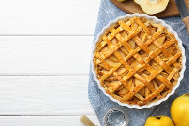 Tasty homemade quince pie on white wooden table, flat lay. Space for text