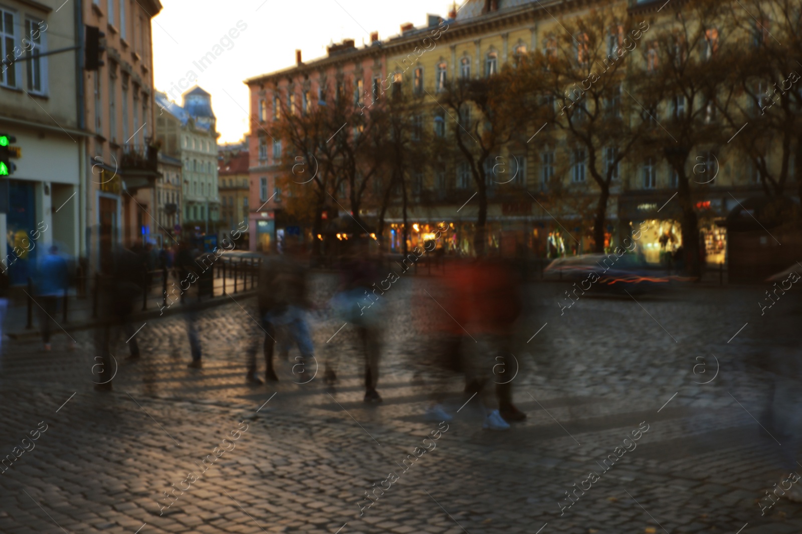 Photo of Blurred view of people crossing street in city