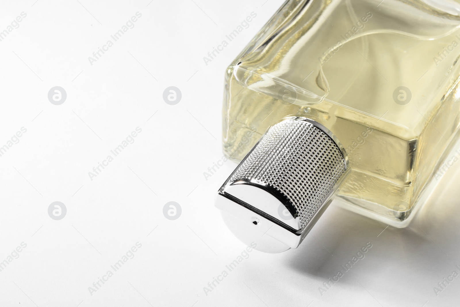 Photo of Luxury men`s perfume in bottle on white background, closeup. Space for text