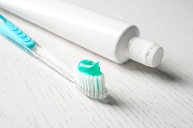 Photo of Manual toothbrush and paste on table. Dental care