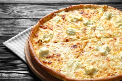 Photo of Tasty hot cheese pizza on wooden background
