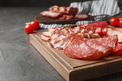 Cutting board with different sliced meat products served on table