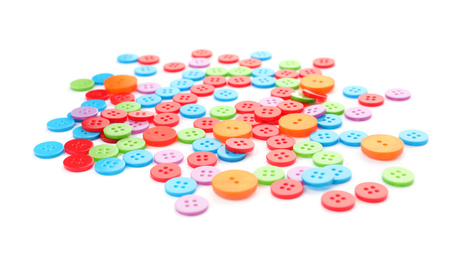 Photo of Many colorful plastic sewing buttons isolated on white