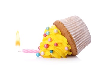 Photo of Dropped cupcake with candle on white background. Troubles happen