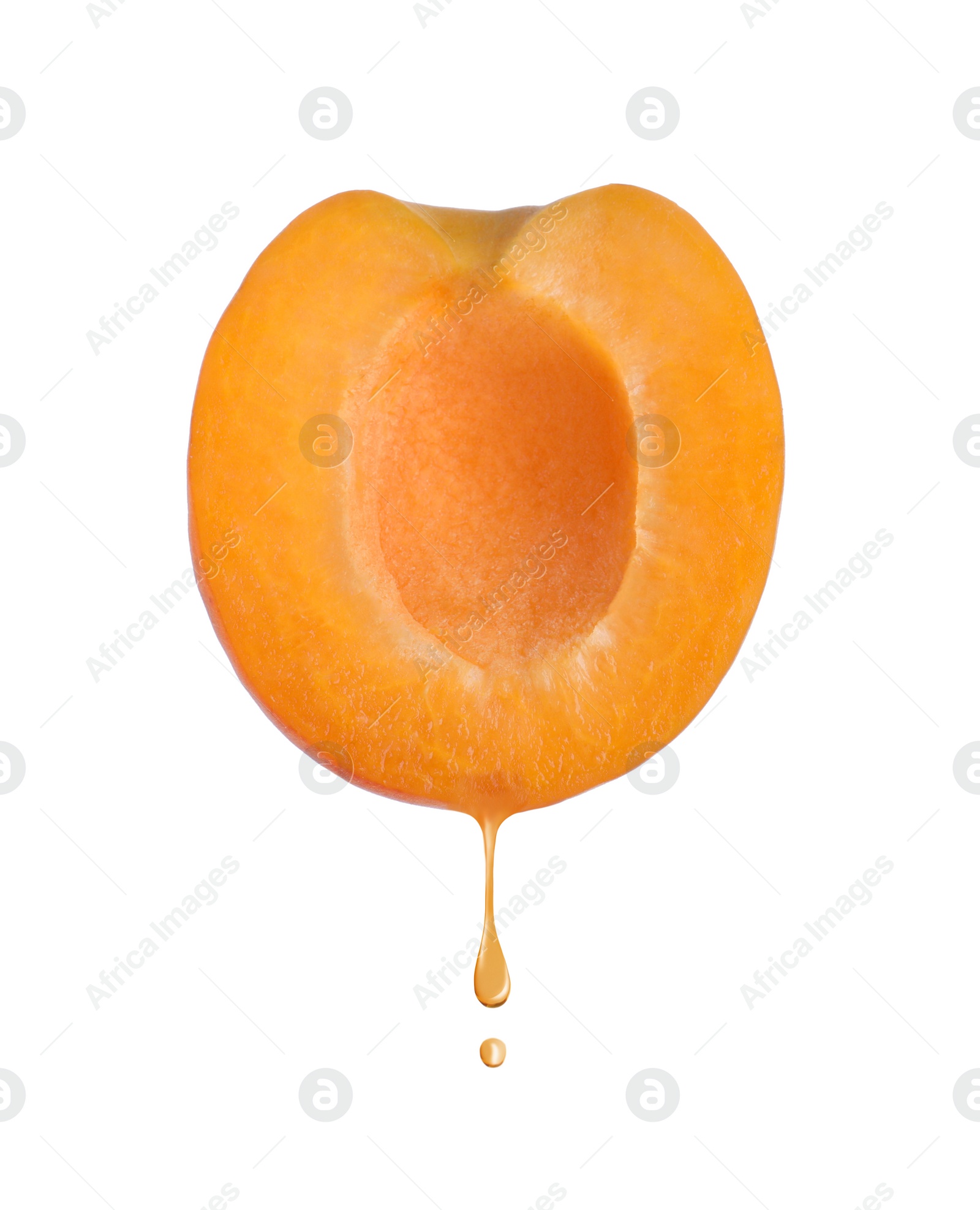 Image of Apricot oil dripping from fresh fruit half on white background