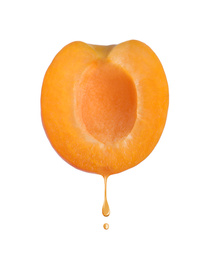 Image of Apricot oil dripping from fresh fruit half on white background