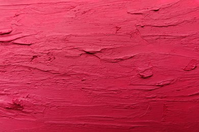 Photo of Texture of bright lipstick as background, top view