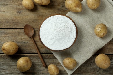 Starch and fresh raw potatoes on wooden table, flat lay