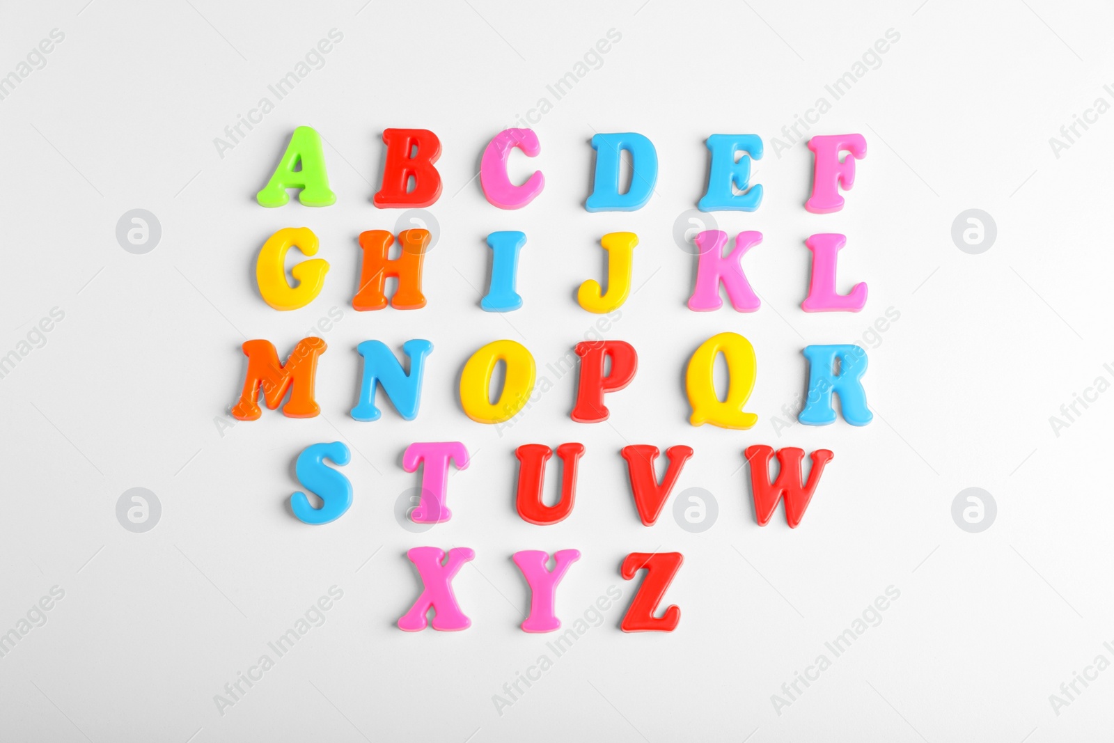 Photo of Colorful magnetic letters on white background, flat lay. Alphabetical order