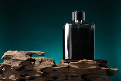 Luxury men`s perfume in bottle against color background, space for text