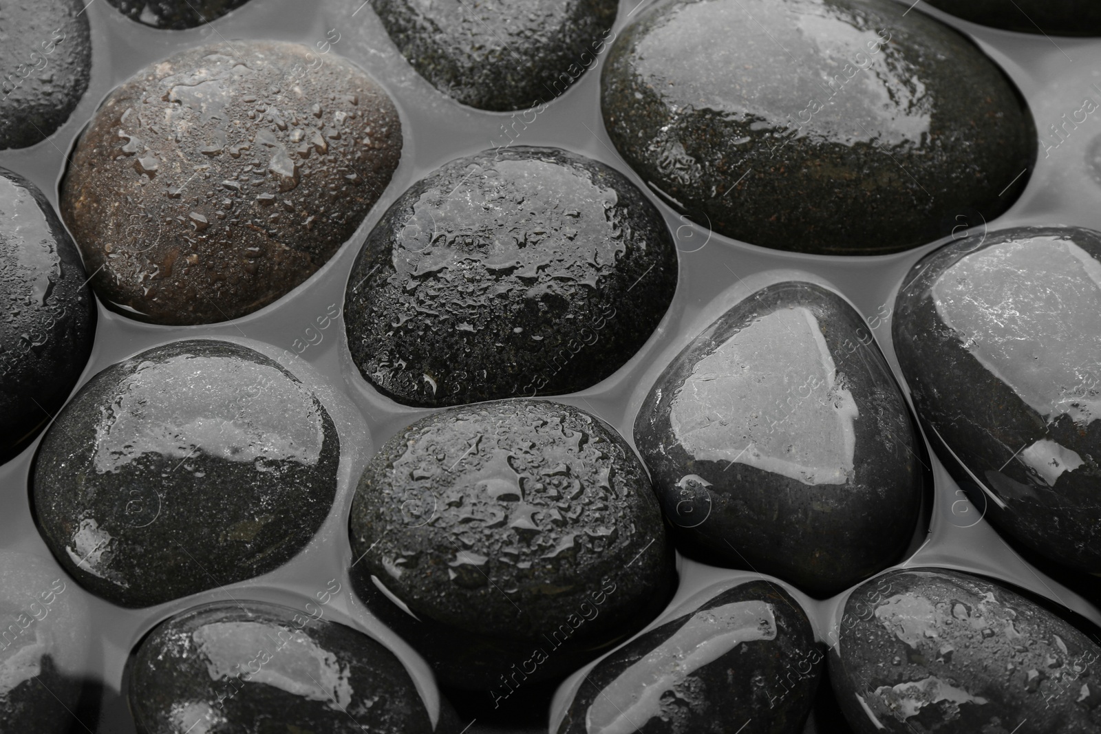 Photo of Spa stones in water as background, top view. Zen lifestyle