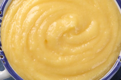 Photo of Delicious lemon curd in bowl, top view