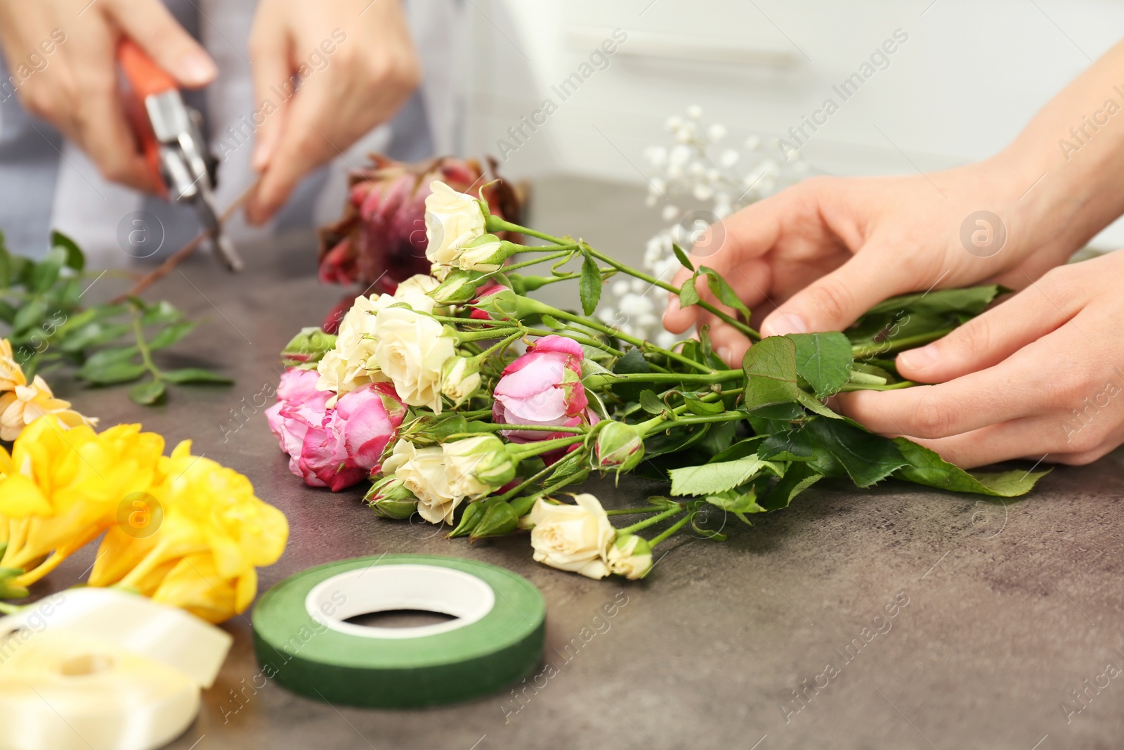 Photo of Female florists making beautiful bouquet at table