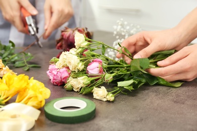 Female florists making beautiful bouquet at table