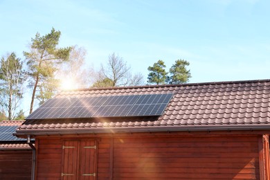 Photo of House with installed solar panels on roof. Alternative energy