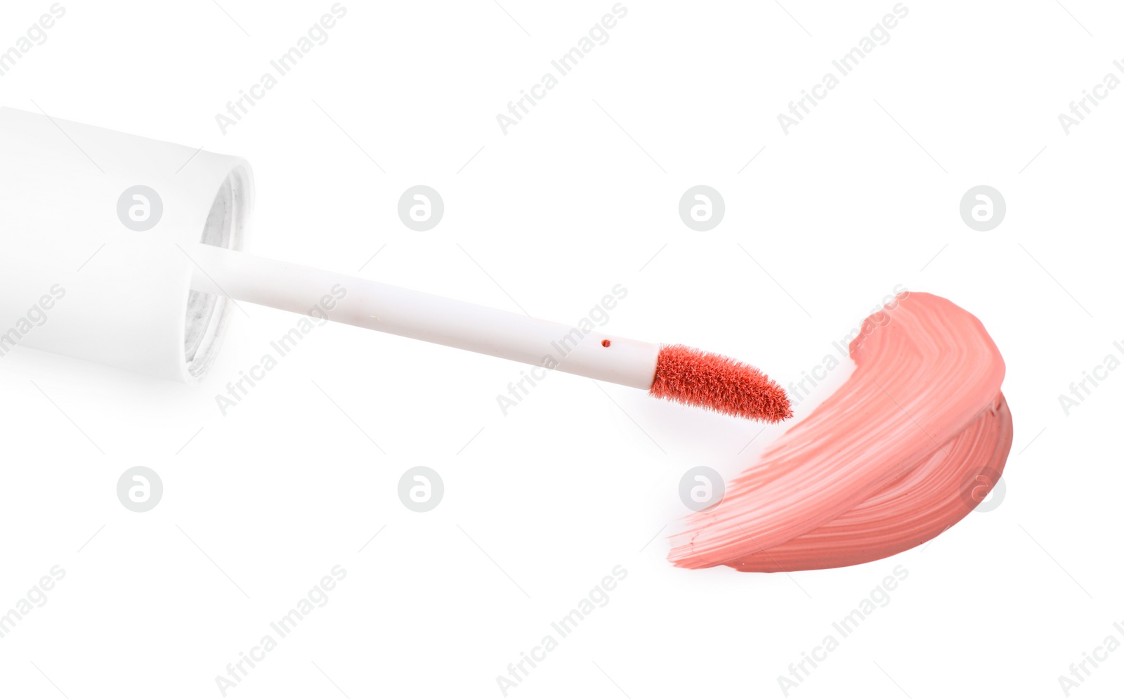 Photo of Strokes of color lip glosses and applicator isolated on white