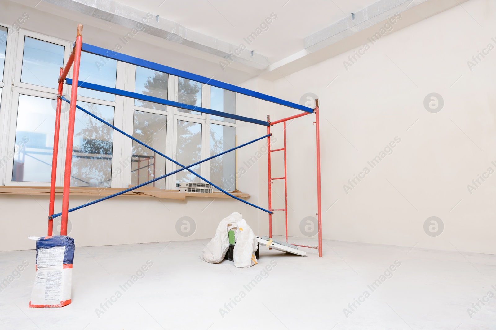 Photo of Empty building with ladder and beige walls during renovation